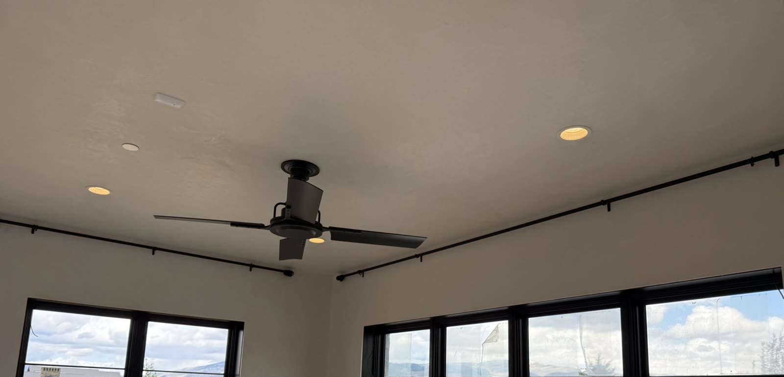 Black decorative drapery rods on two walls, no drapes yet, by Blindznation
