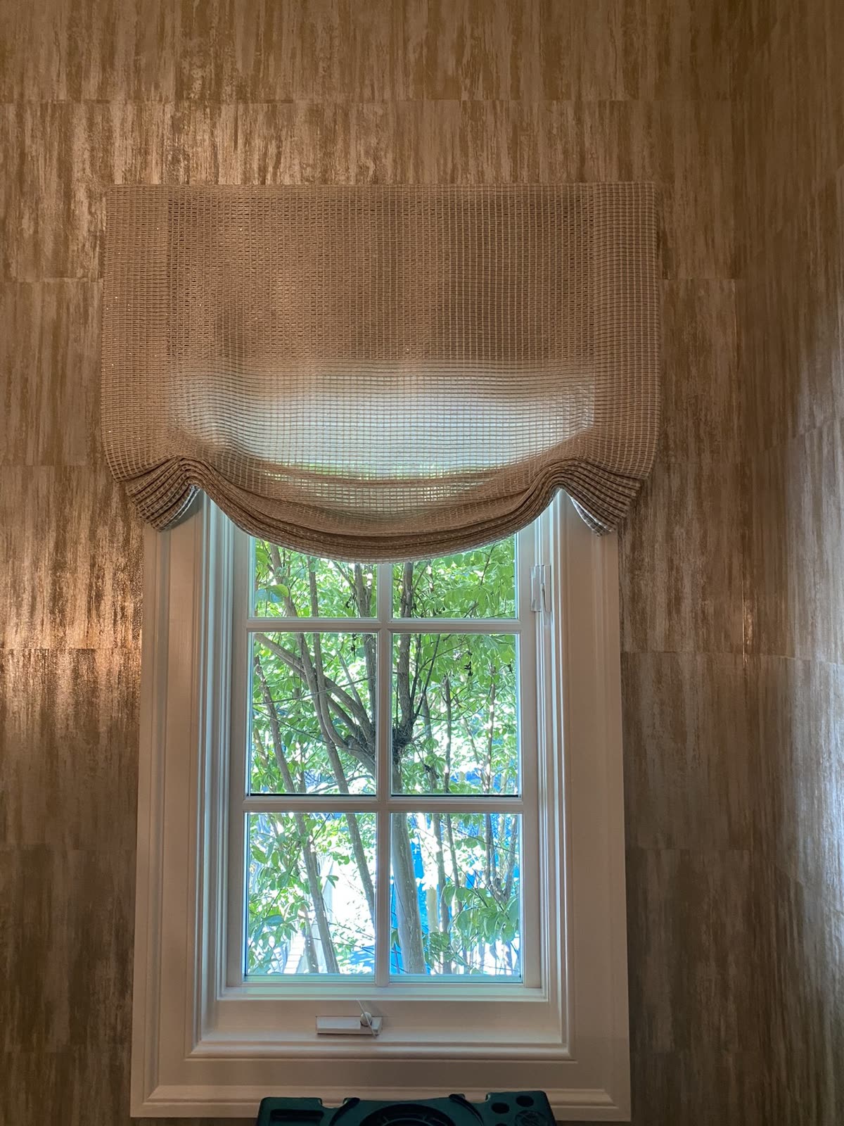 Relaxed Roman shade with a soft curved hem, one of our installs