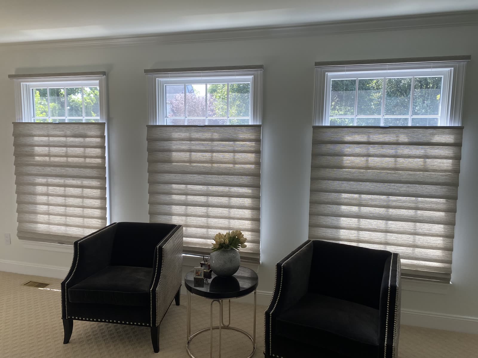 Top-down shades on three windows in a sitting room, one of our installs